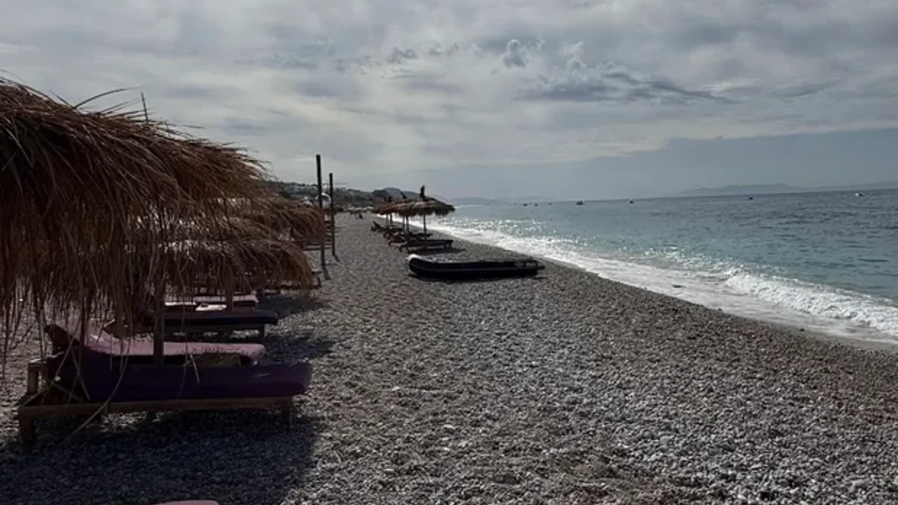 The Dhërmi seafront and turquoise water in peak summer
