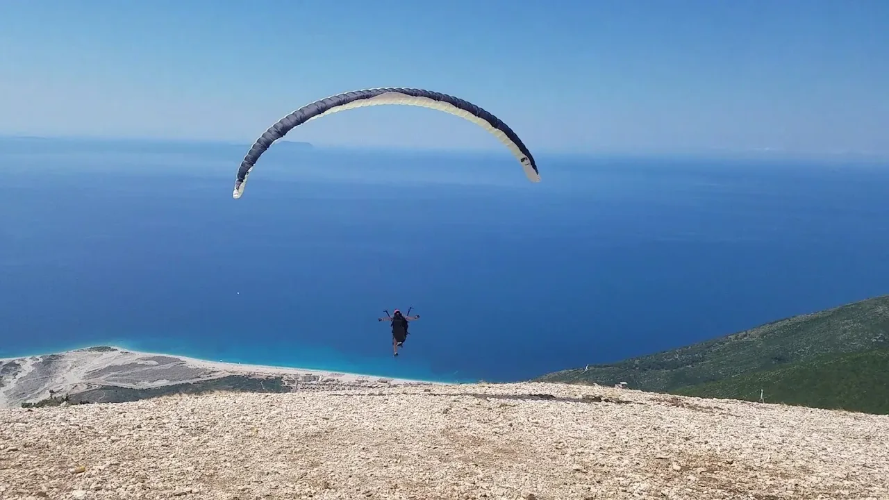 A paraglider above the Llogara Pass and the Ionian coast on the Albanian Riviera