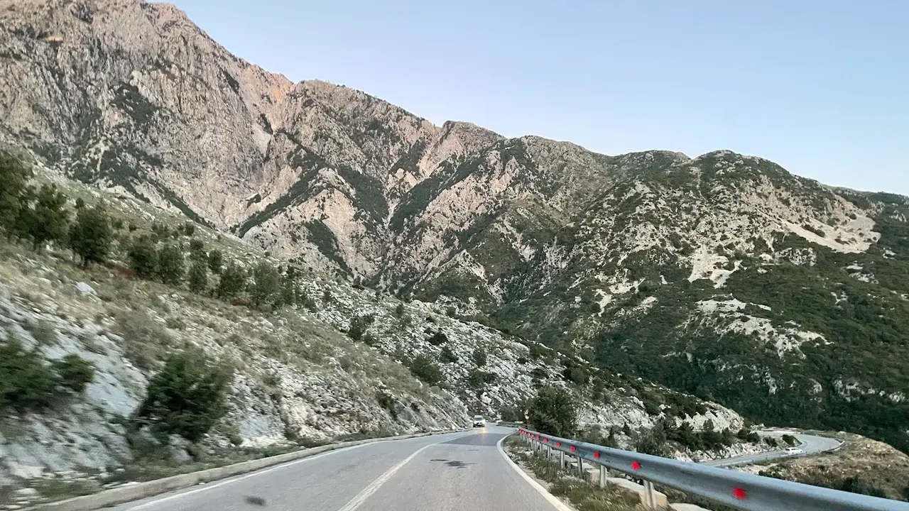 The SH8 mountain road climbing through the rugged Ceraunian range near the Llogara Pass above the Ionian coast