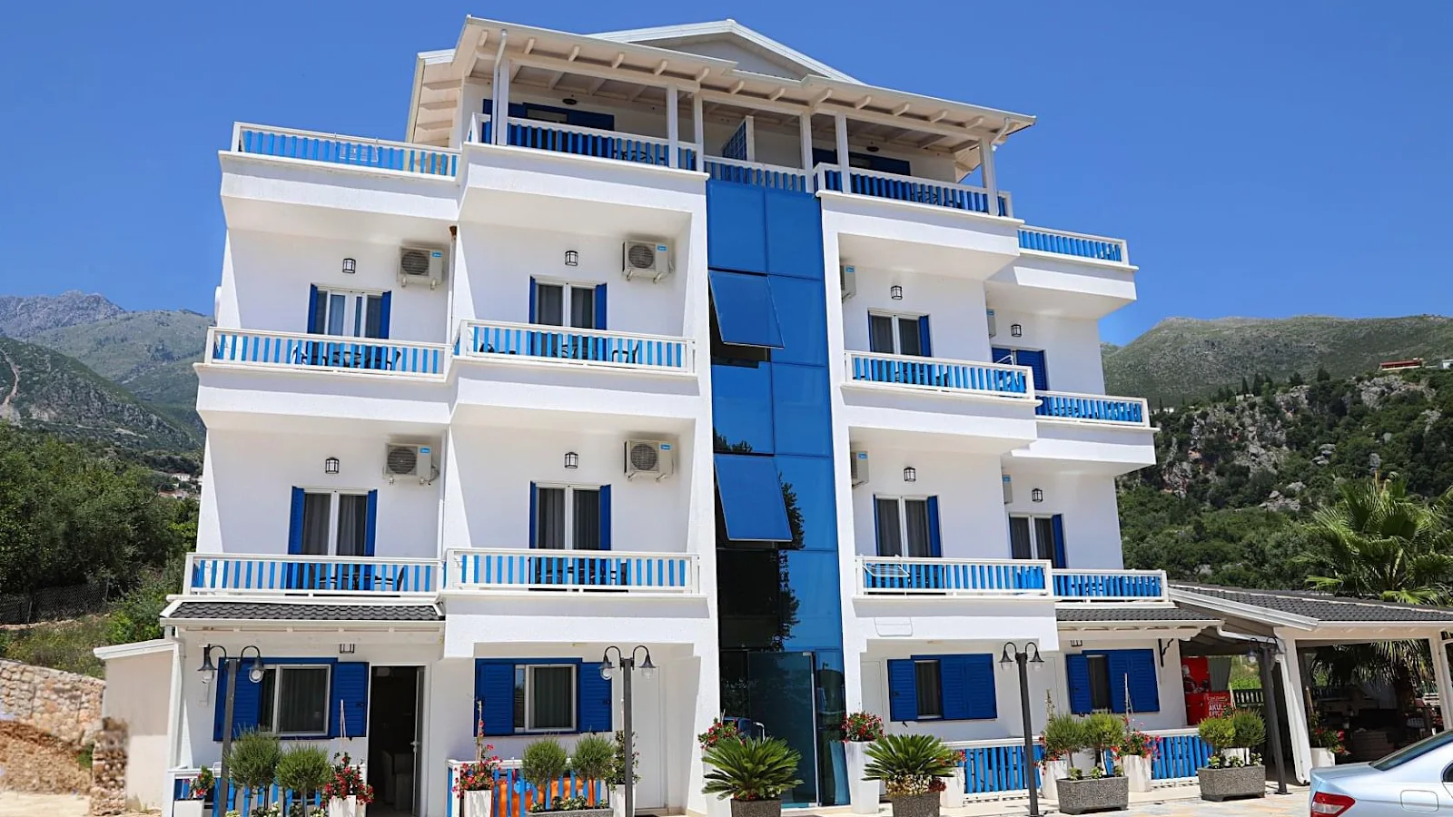 The blue-and-white facade of Hotel Sofo in Dhërmi