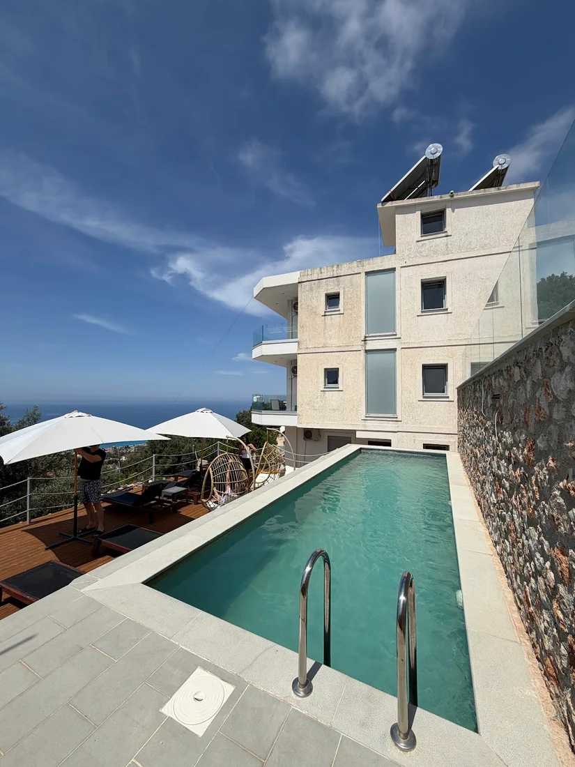 The hillside pool and sea view at Ionian Pearl above Drymades