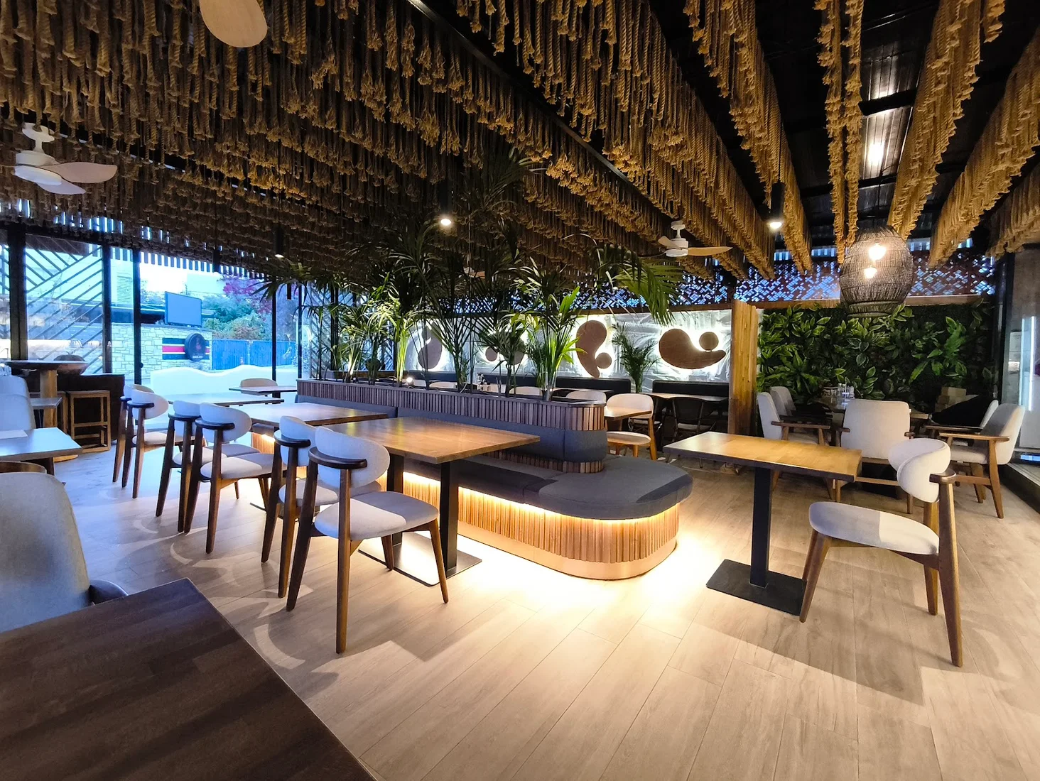 The rope-and-macramé ceiling and banquette dining room of Jon Restorant near Dhërmi Beach