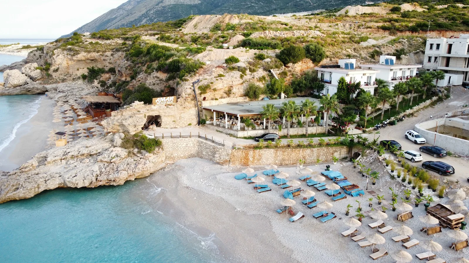 Aerial view of the Summer Dream terrace restaurant and beach cove at Drymades, Dhërmi