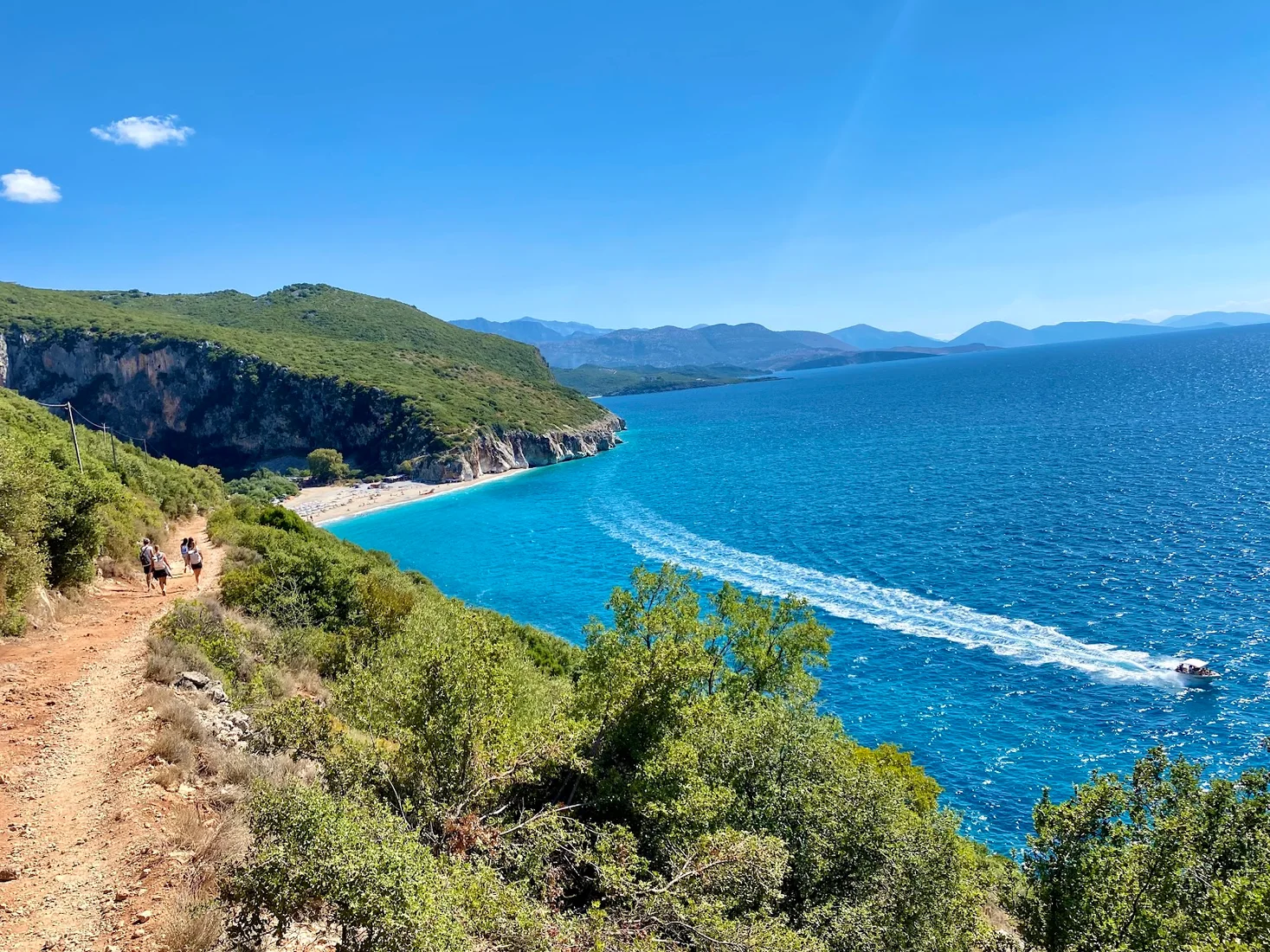 Dhërmi beach and turquoise water below the Ceraunian Mountains on the Albanian Riviera