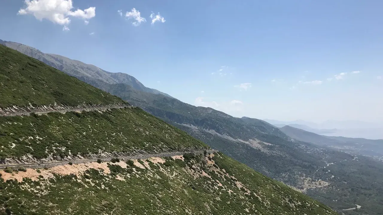 A hire car on the coast road above the Ionian Sea on the Albanian Riviera near Dhërmi