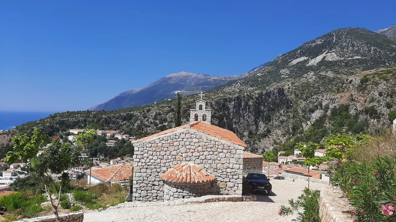 The stone lanes of Dhërmi's old village above the Albanian Riviera, where stray dogs are a common sight