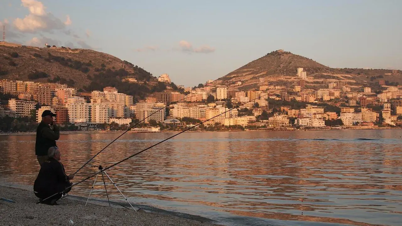 The waterfront town of Sarandë rising above its bay at golden hour, on the Albanian coast