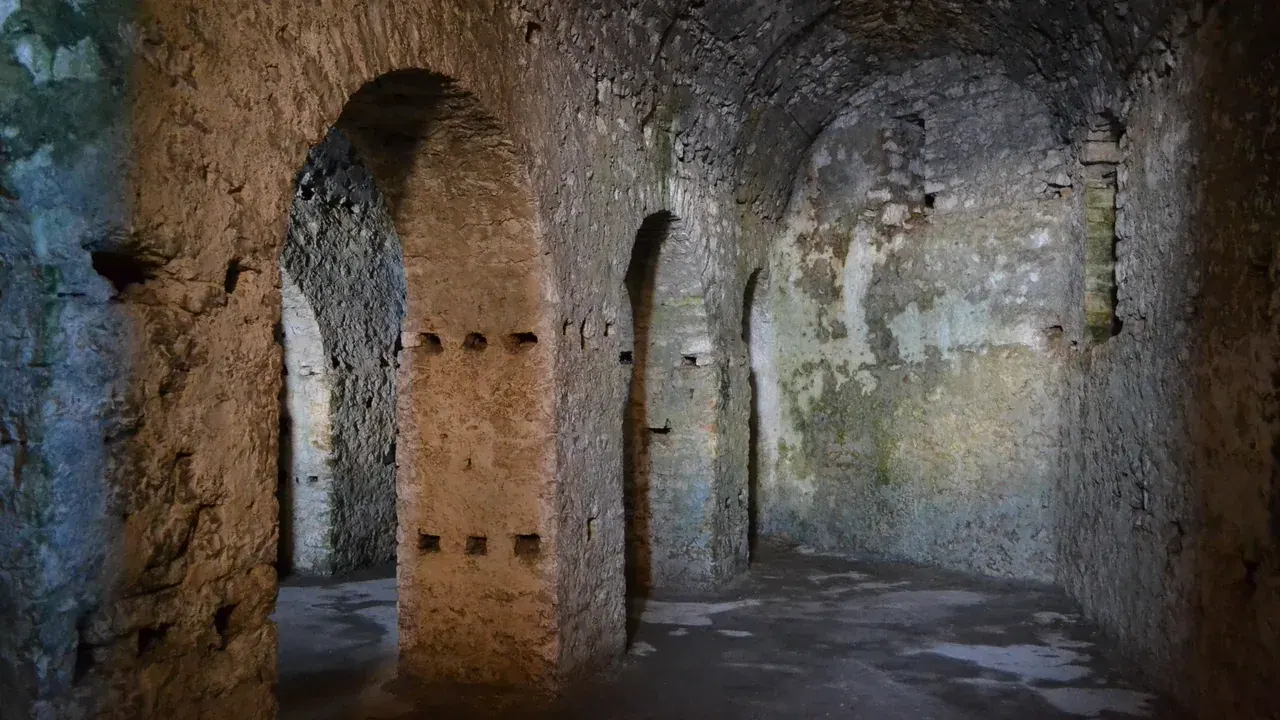 Vaulted stone chambers inside Porto Palermo Castle, the triangular fortress on the bay south of Himarë
