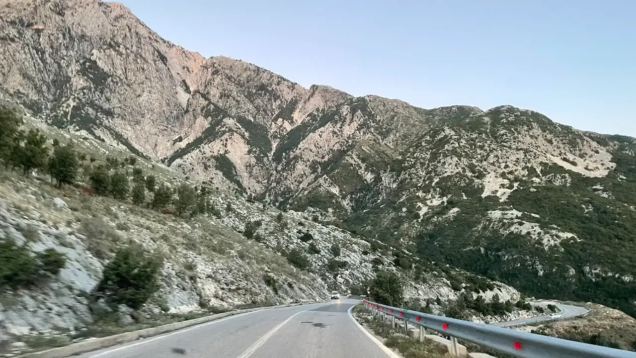 The SH8 mountain road climbing through the rugged Ceraunian range near the Llogara Pass above the Ionian coast
