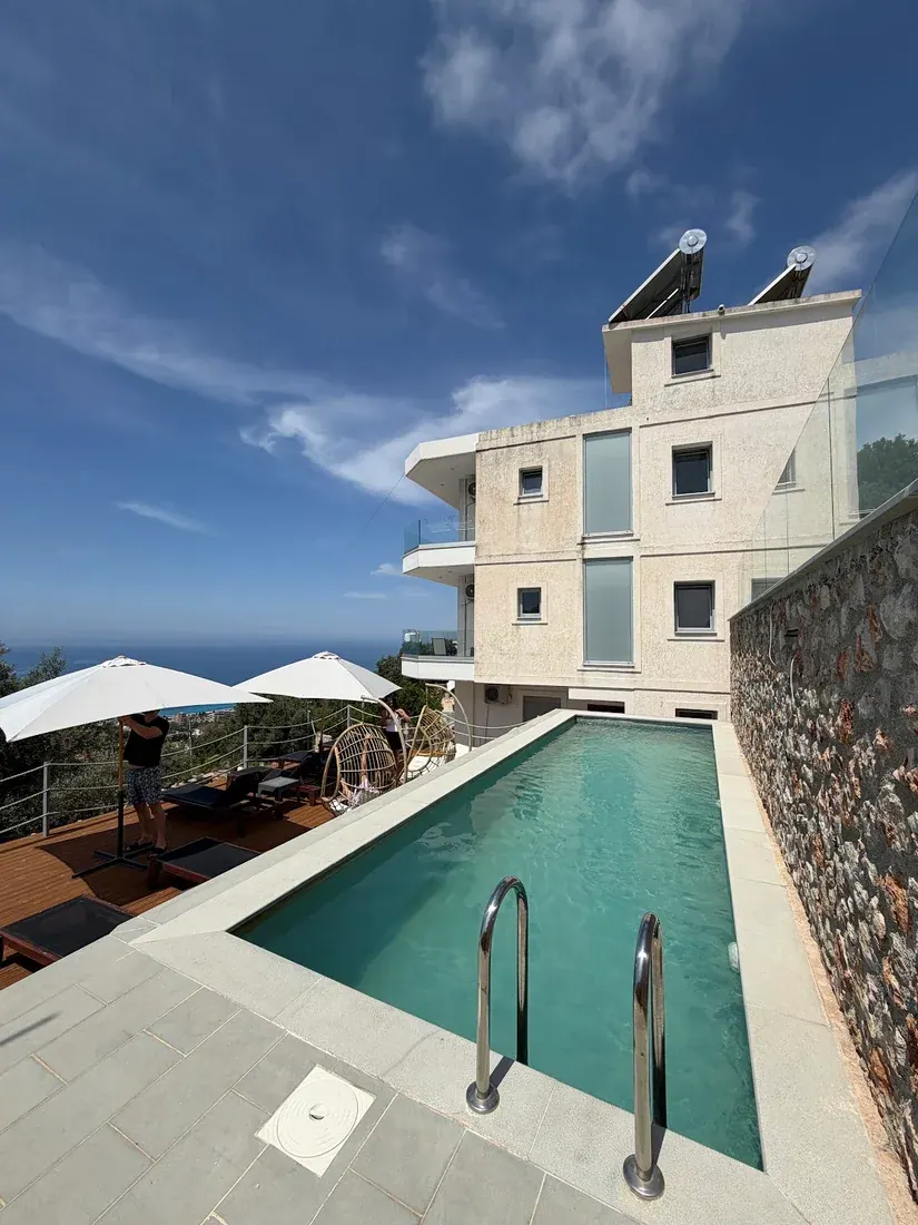 The hillside pool and sea view at Ionian Pearl above Drymades