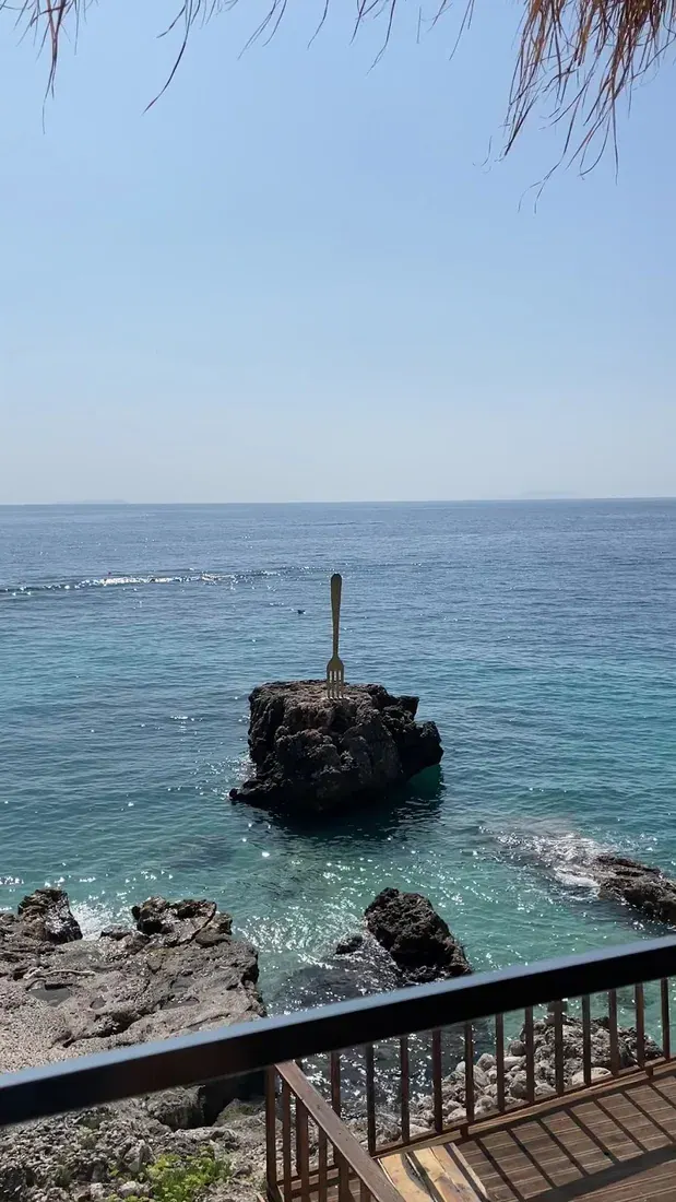 Clear turquoise water off a rocky point at Dhërmi Beach