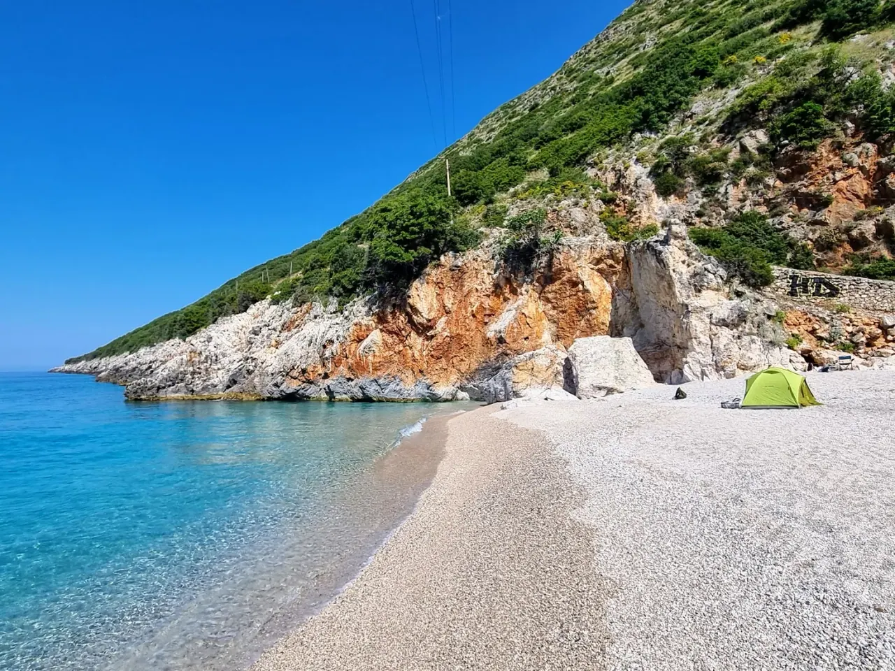 Clear water and orange cliffs at the Gjipe cove