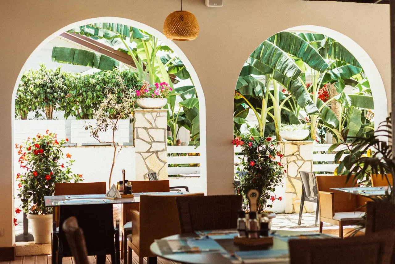 The arched, plant-filled veranda of Royal Blue Restaurant on Dhërmi Beach