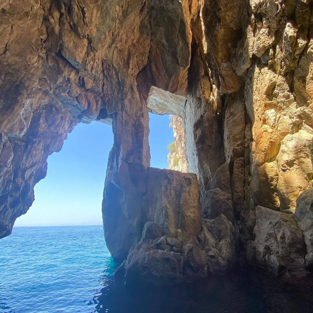 A sea cave and clear water on the coast near Dhërmi visited on a Pirates' Cave boat tour